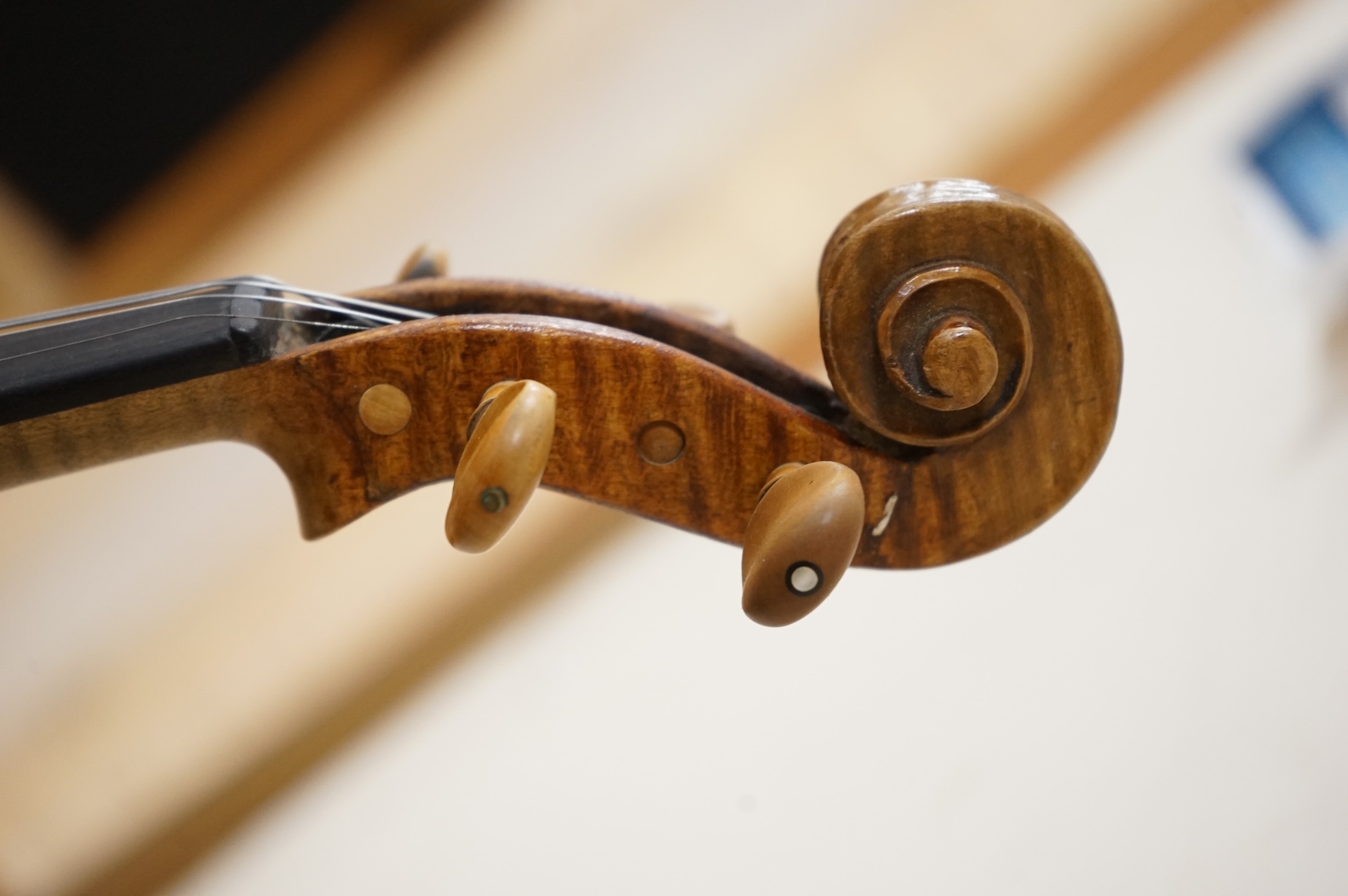 Five cased 20th century violins, including; a German violin, two Czech violins, a three-quarter size violin with a label for Bienfait, and a Romanian quarter size violin, all in cases or the remains of cases.